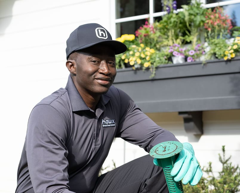 Hawx pest control technician working on a garden