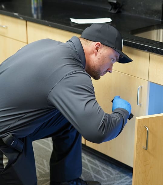 Hawx pest control technician inspecting commercial property